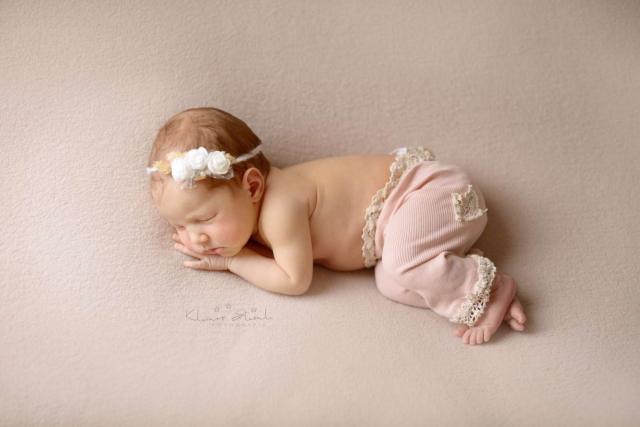 Newborn baby sleeps during the photo shoot in London