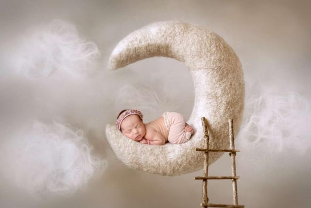 Sleeping newborn baby on the moon